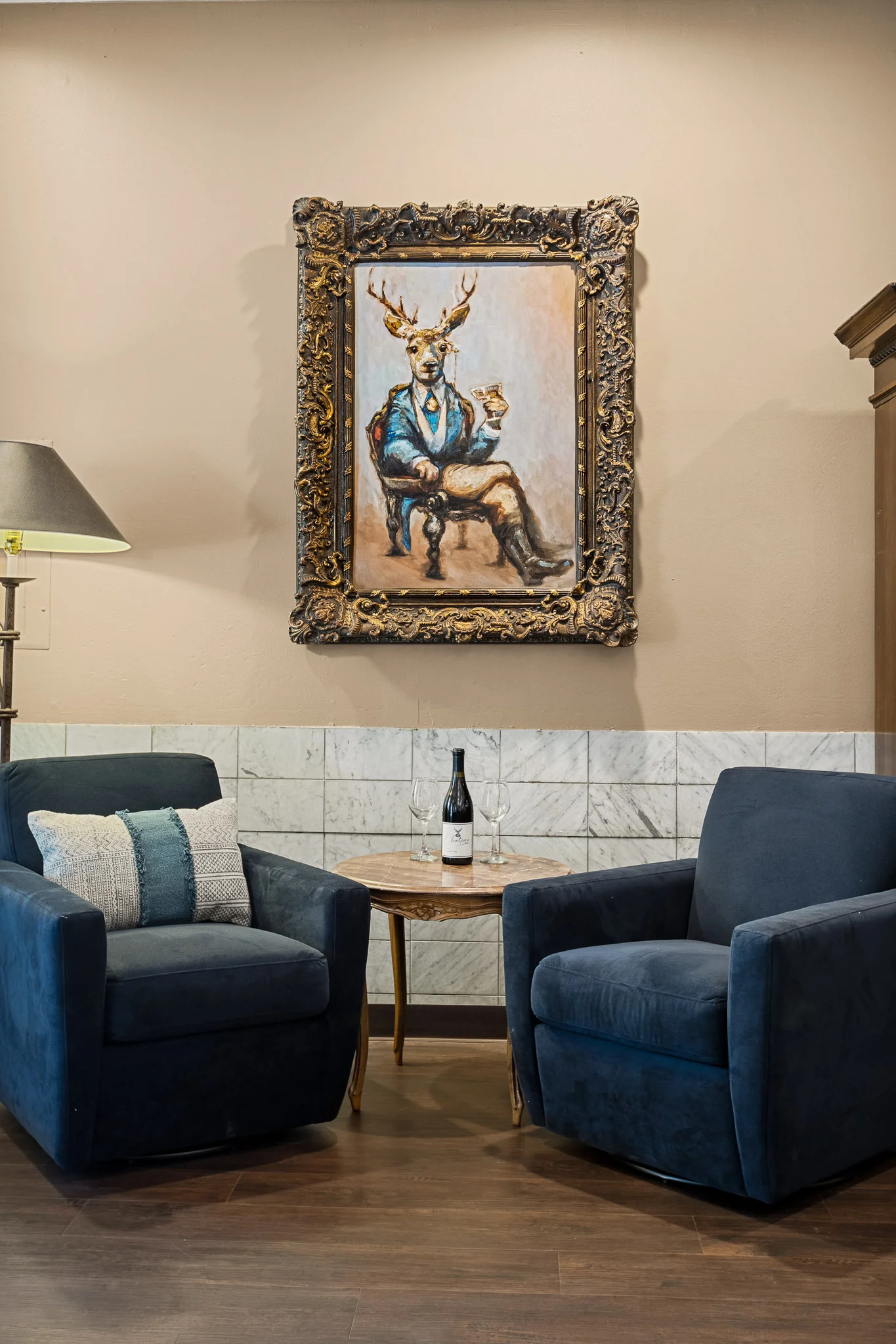 lounge area chairs with wine table and deer painting